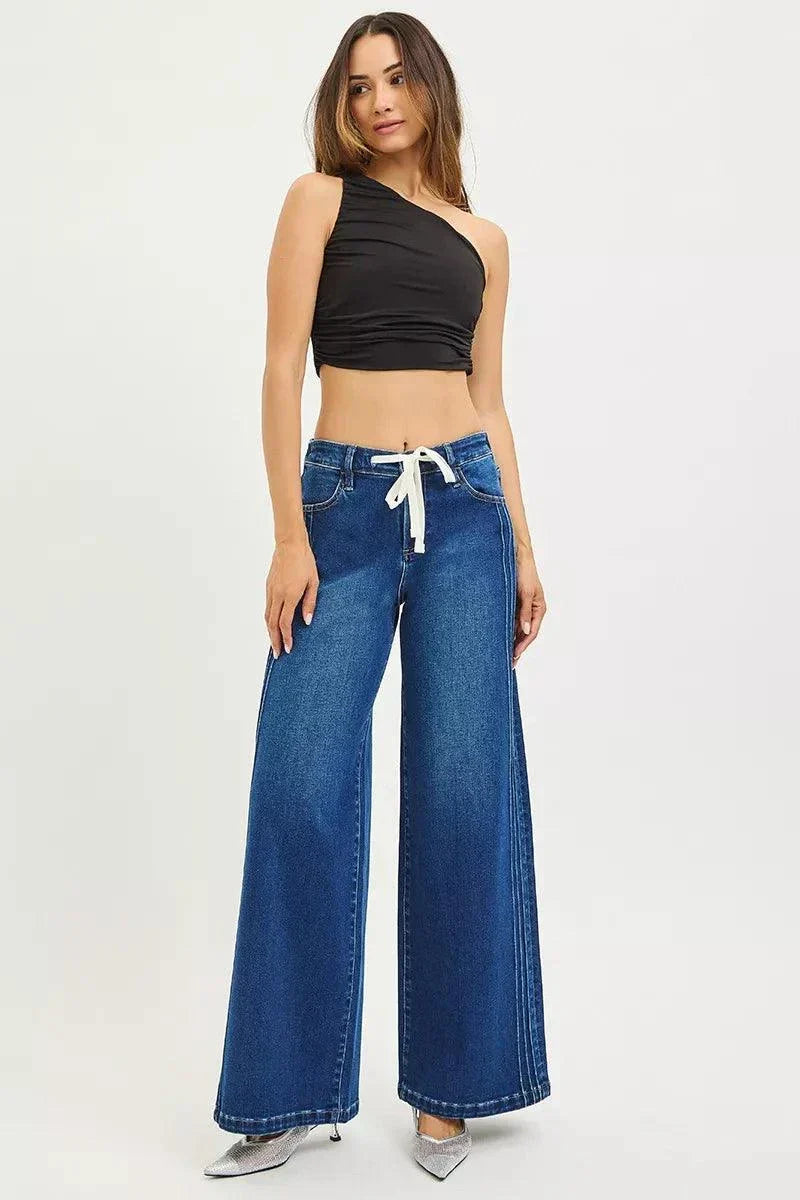 Full size mid rise wide side pintuck jeans with front drawstring plus size model wearing blue denim