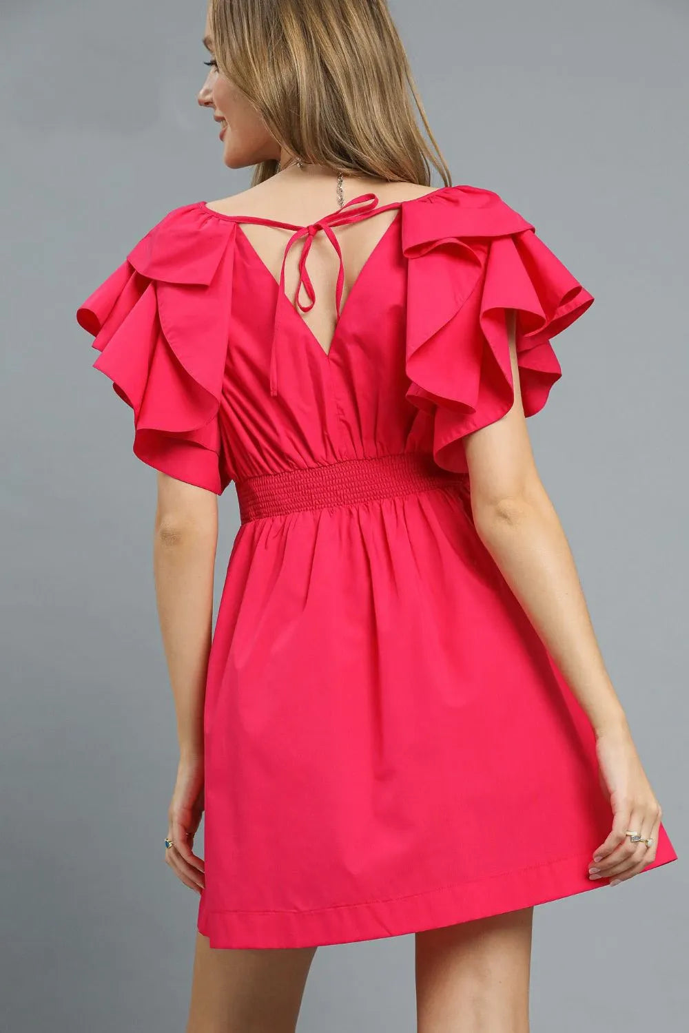 Back view of Umgee Double Ruffle Sleeve Fit and Flare hot pink dress with tied neckline and tiered ruffle sleeves