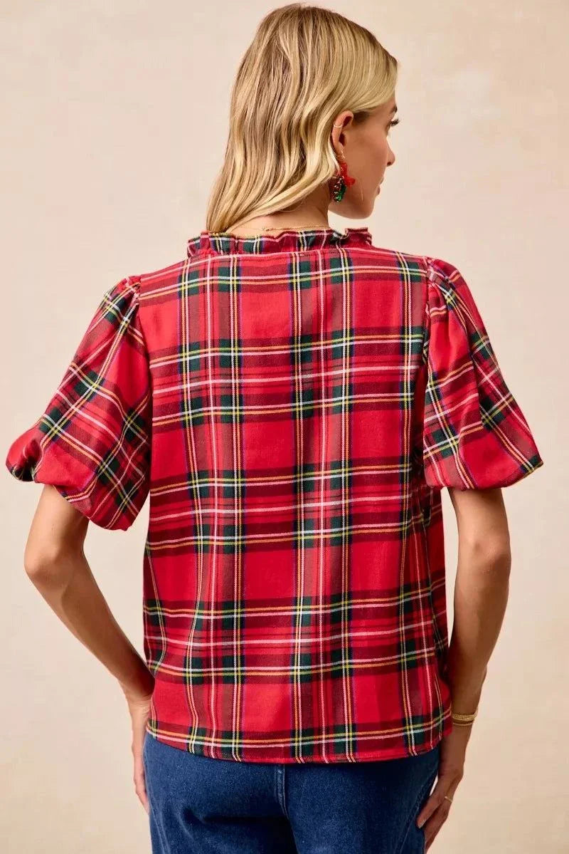 BiBi Christmas Plaid Short Sleeves Ruffled BlouseThis Christmas plaid short sleeves ruffled blouse is a festive and charming addition to your holiday wardrobe. The classic plaid pattern evokes a cheerful and cozy hChristmas plaid blouse