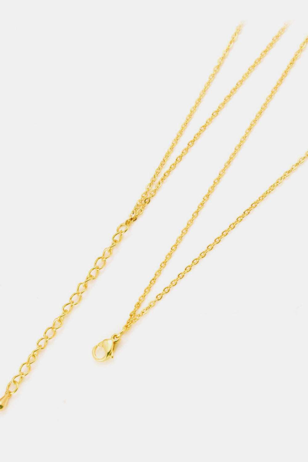 gold linked ring pendant chain necklace flat lay brass jewelry with clasp and extension chain