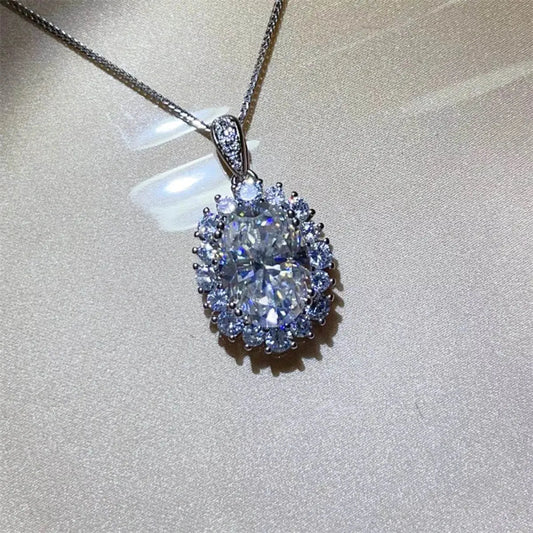 8 Carat Moissanite pendant necklace in 925 sterling silver with platinum plating and oval-shaped center stone surrounded by smaller stones on a 17.7-inch chain