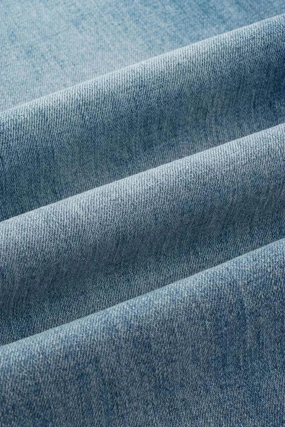 Close-up of soft blue denim fabric for Button Fly High Waist Jeans