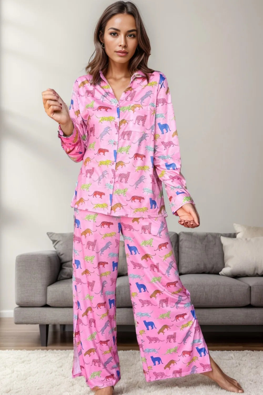 Woman wearing pink pocketed printed top and pants lounge set with multicolored animal print in living room