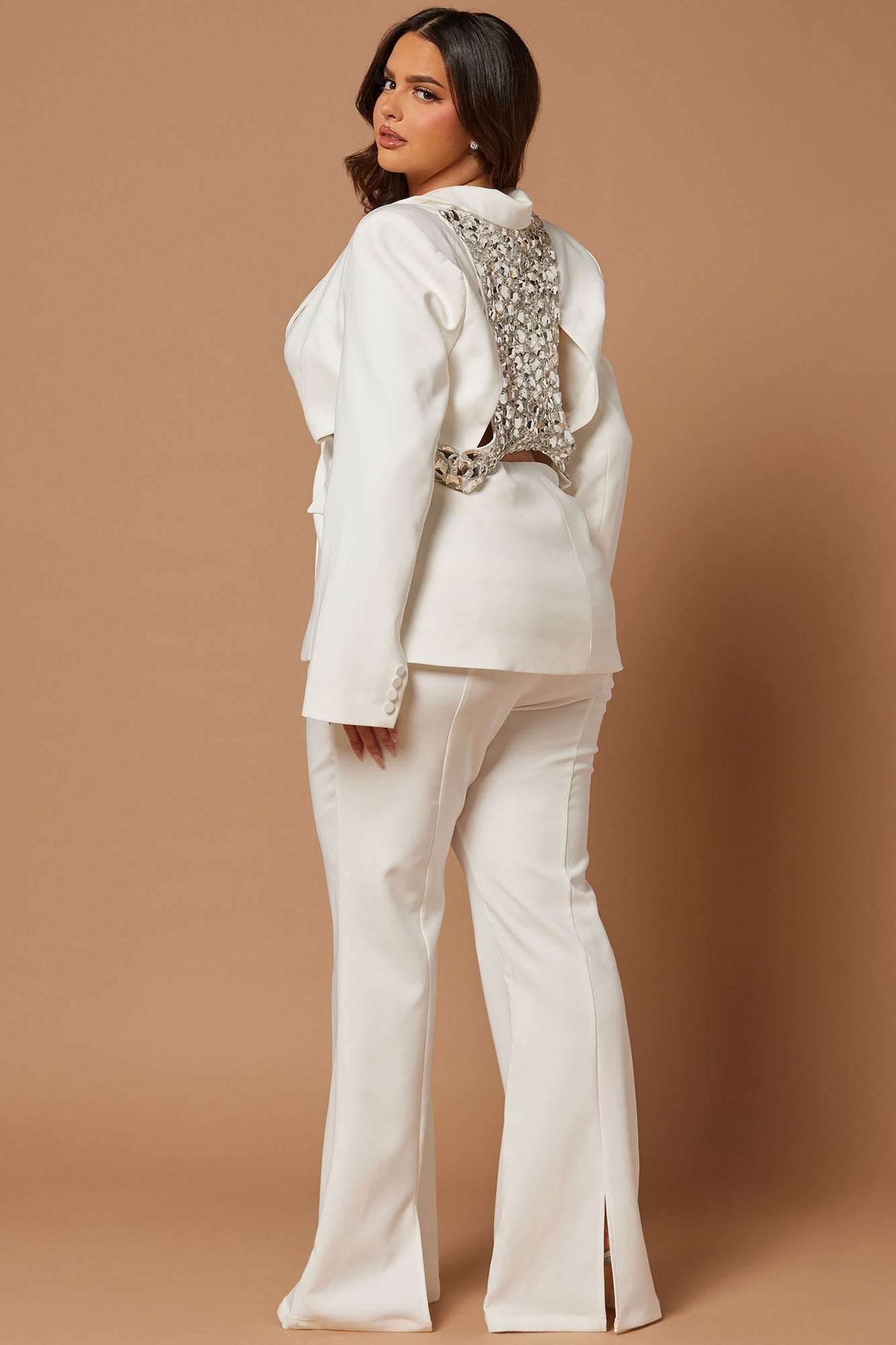 Woman wearing white Skyla embellished blazer suit set with decorative back detailing