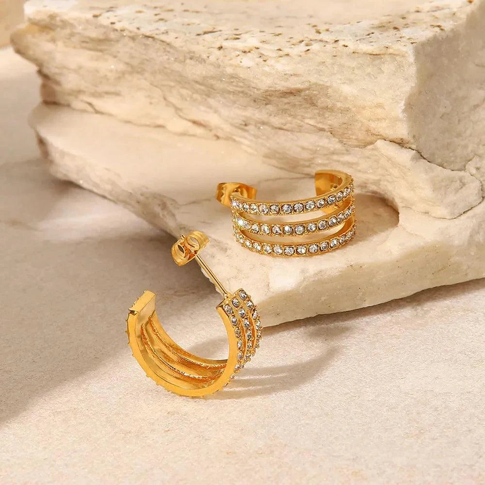Gold-plated stainless steel C-hoop earrings with zircon inlay on stone surface