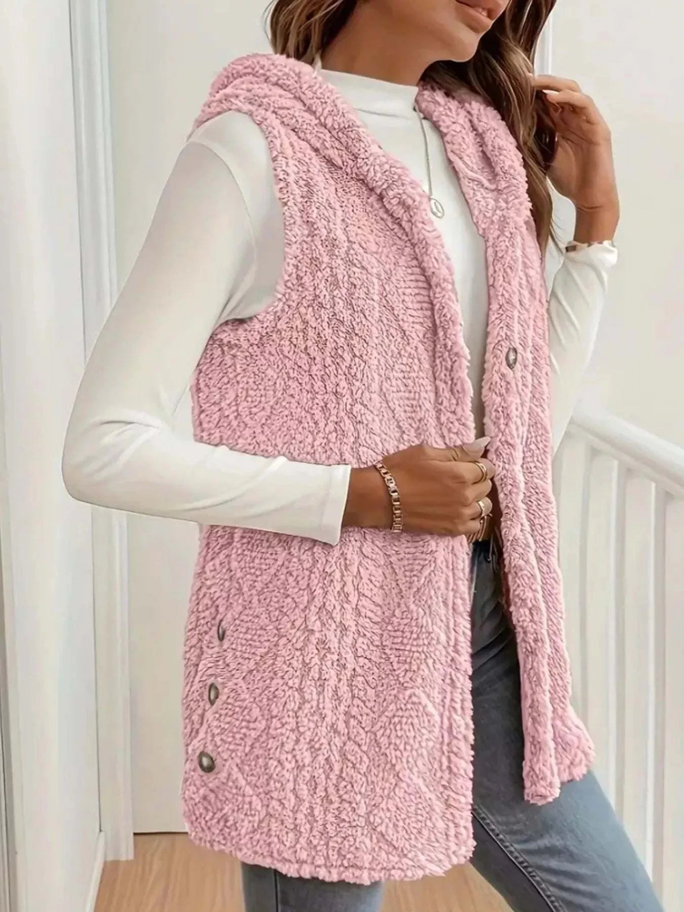 Button Up Plush Hooded Vest in pink sherpa fleece with side buttons and hood, worn over white long sleeve top