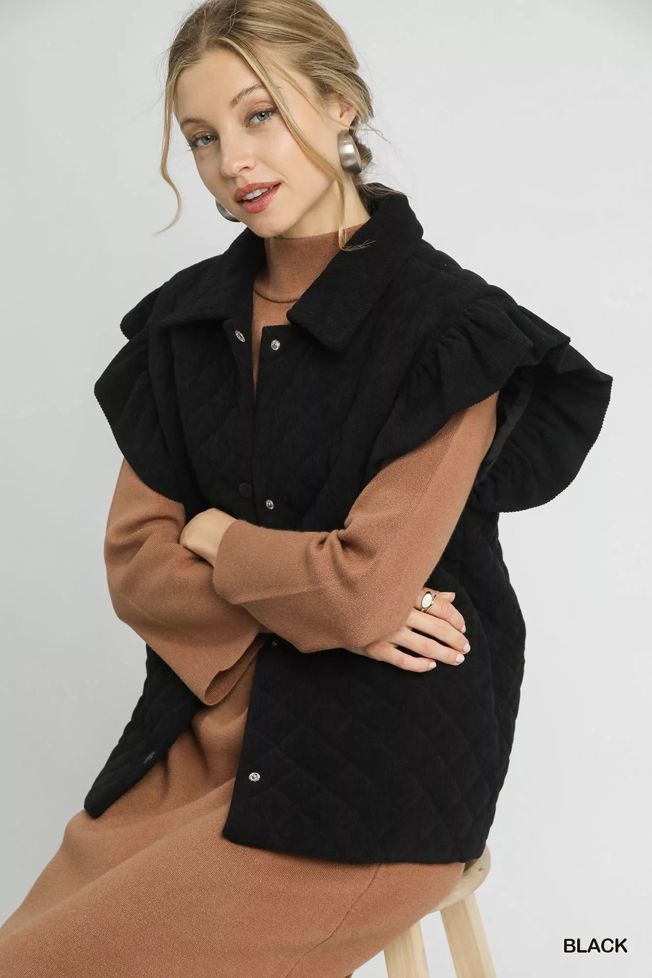 Umgee black corduroy quilted vest with ruffle sleeves and snap buttons, styled over brown dress