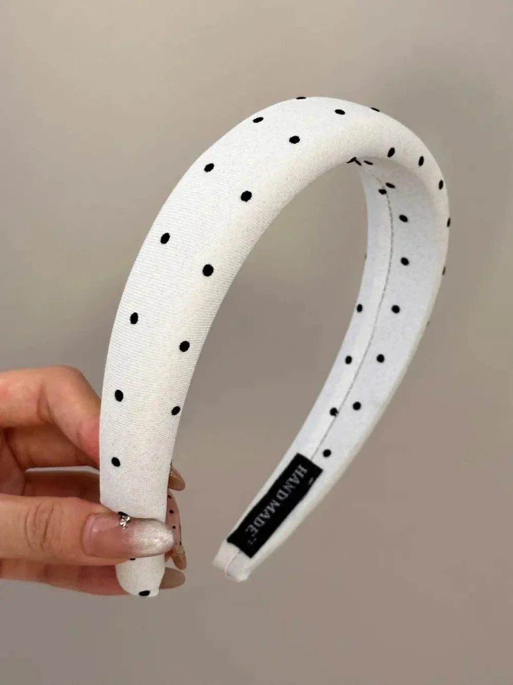 Polka dot polyester wide headband with black dots on white background handheld accessory