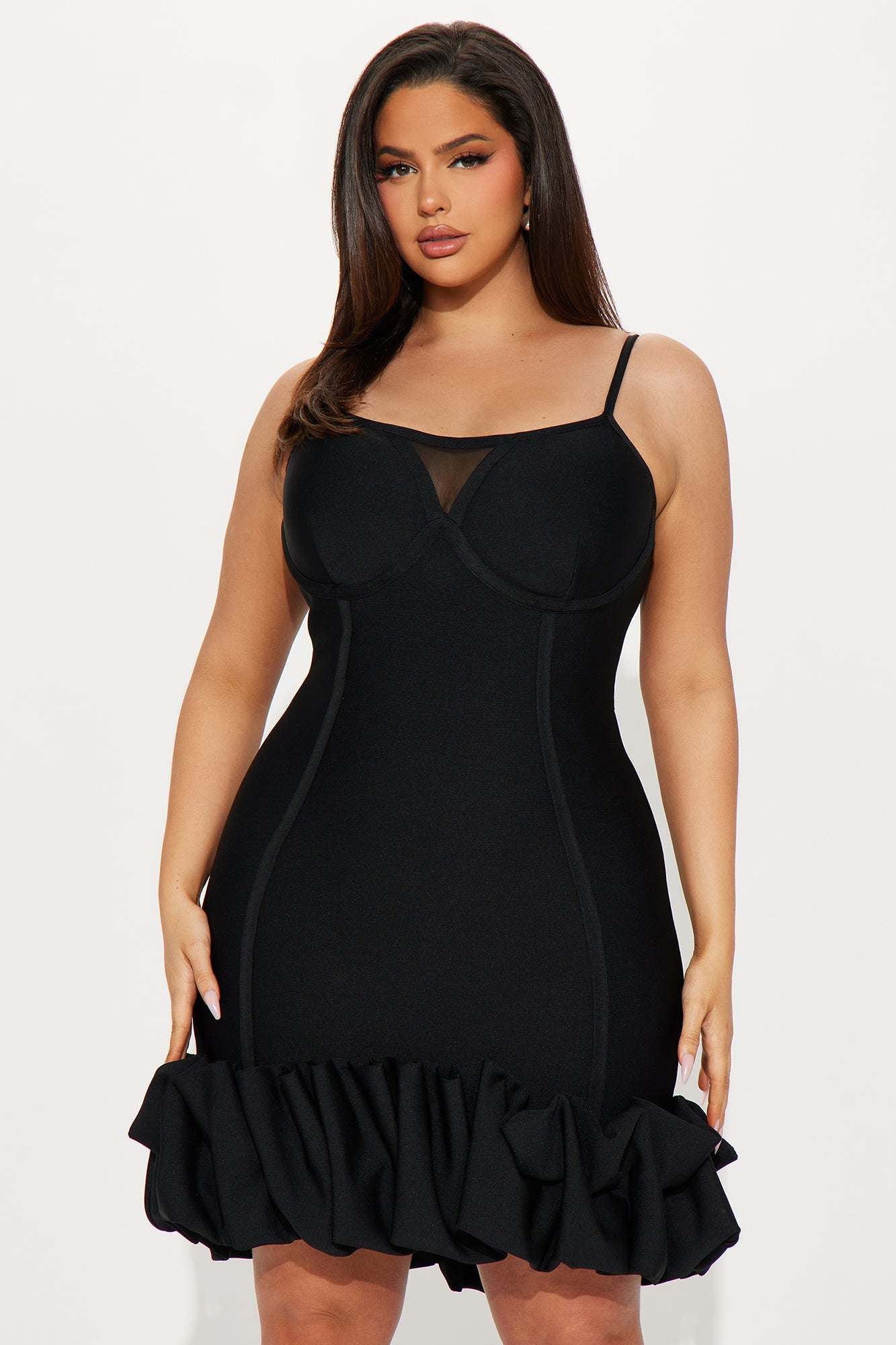 Curvy woman wearing Everly Bandage Mini Dress in black with ruffled hem and spaghetti straps