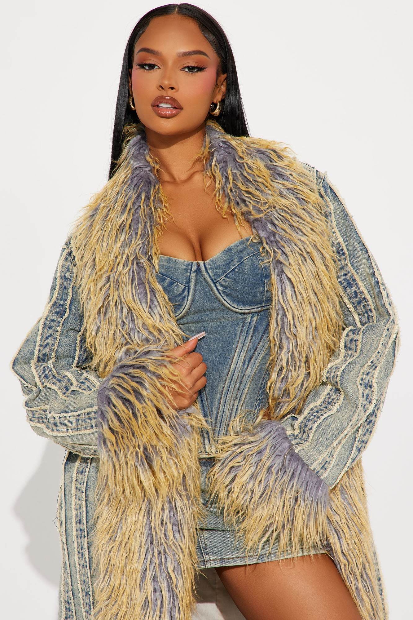 Woman wearing Love Me Not vintage wash denim trench coat with fur trim and raw hem