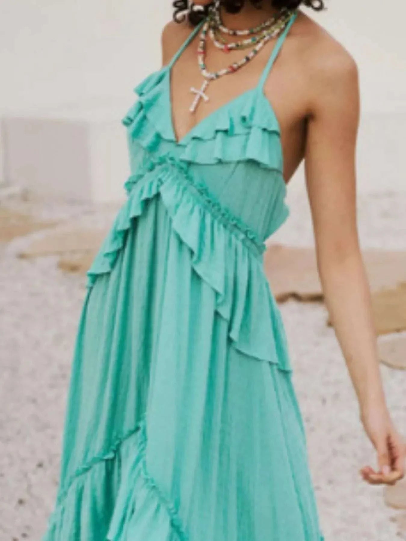 Turquoise ruffled halter neck maxi dress with tied straps and flowing layers