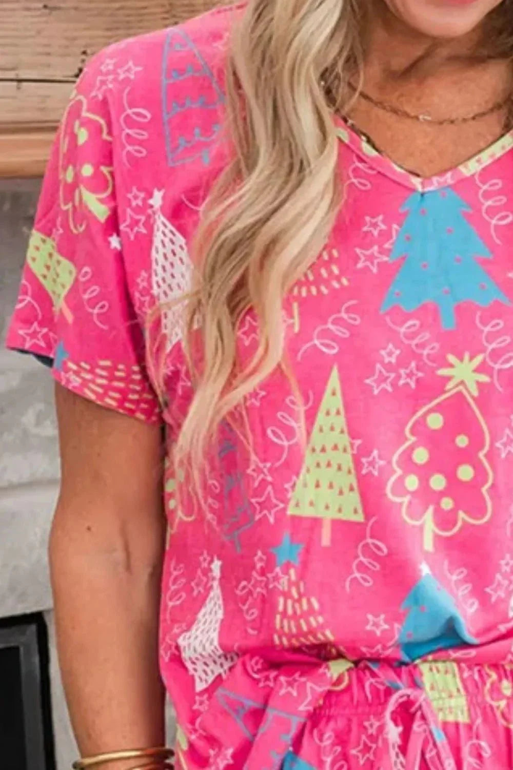 Printed V-Neck pink short sleeve top with colorful holiday tree patterns, paired with matching pants lounge set