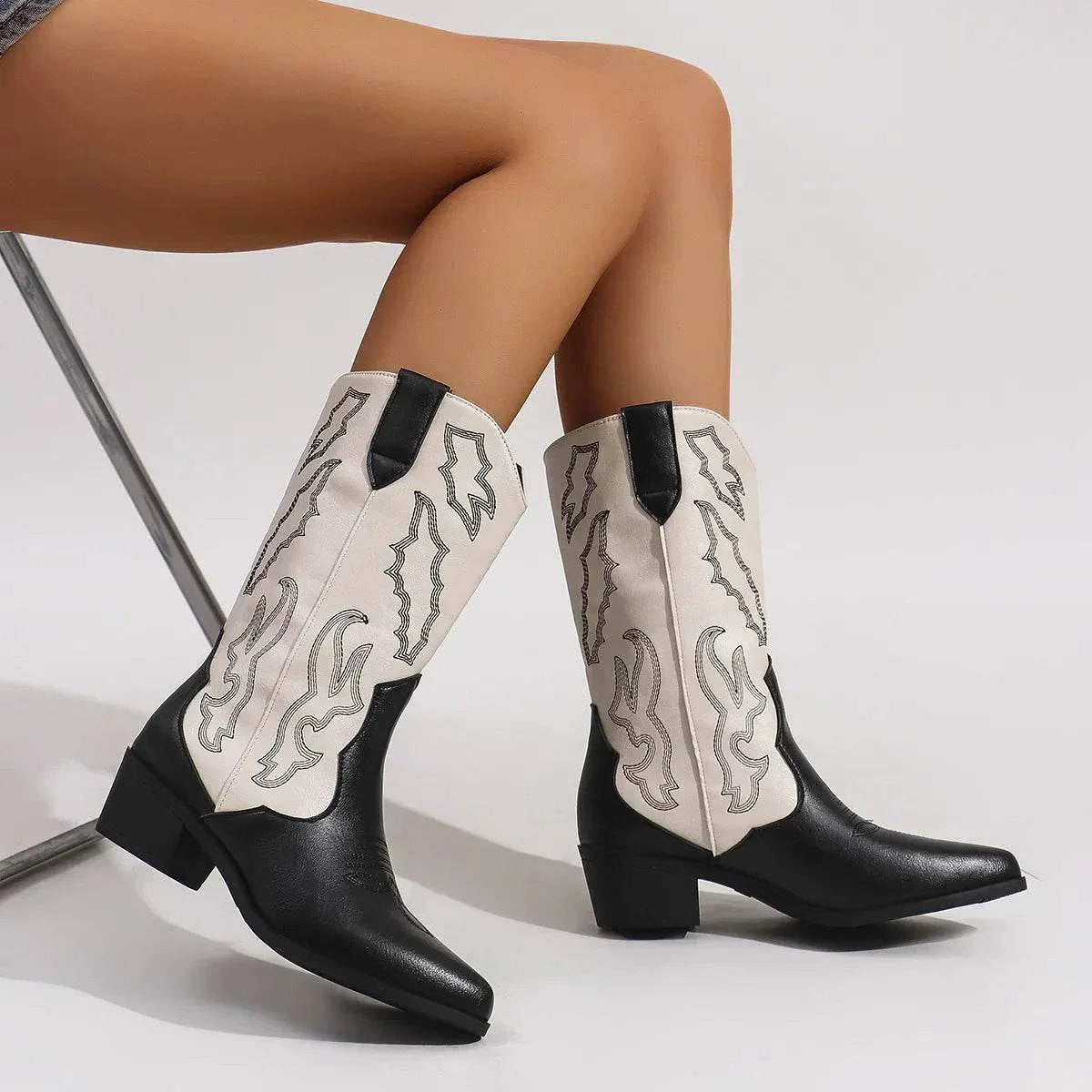 Black and white PU leather point toe block heels boots with mid heels worn by model
