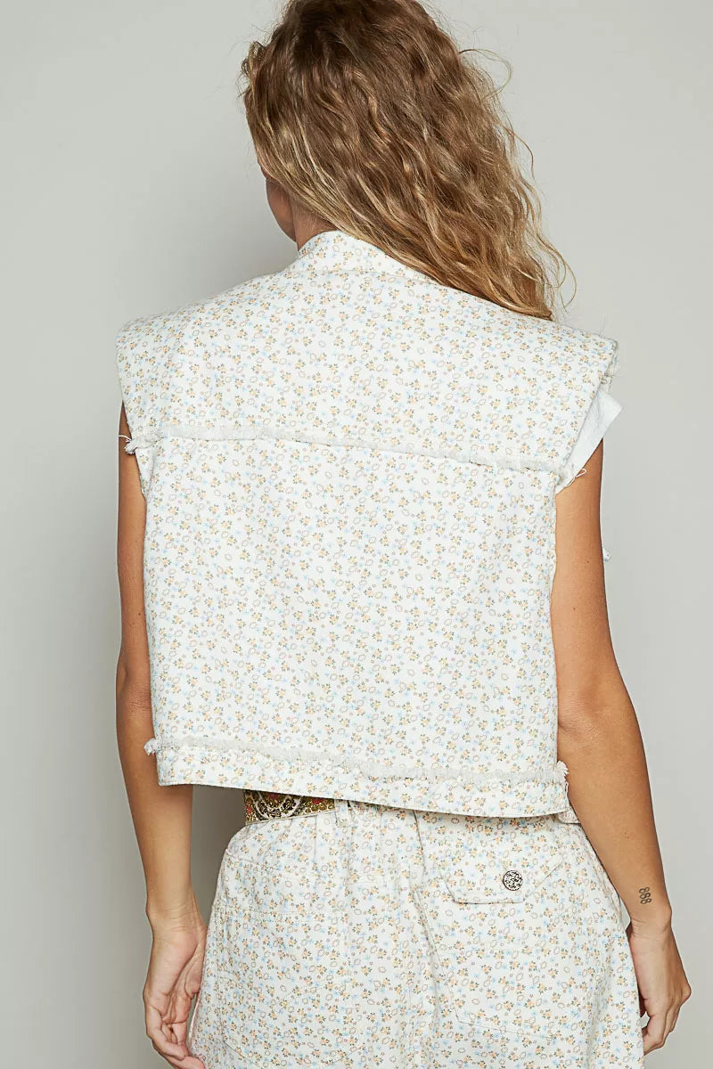 Back view of POL Assymetrical Front Closure floral raw hem denim vest on model