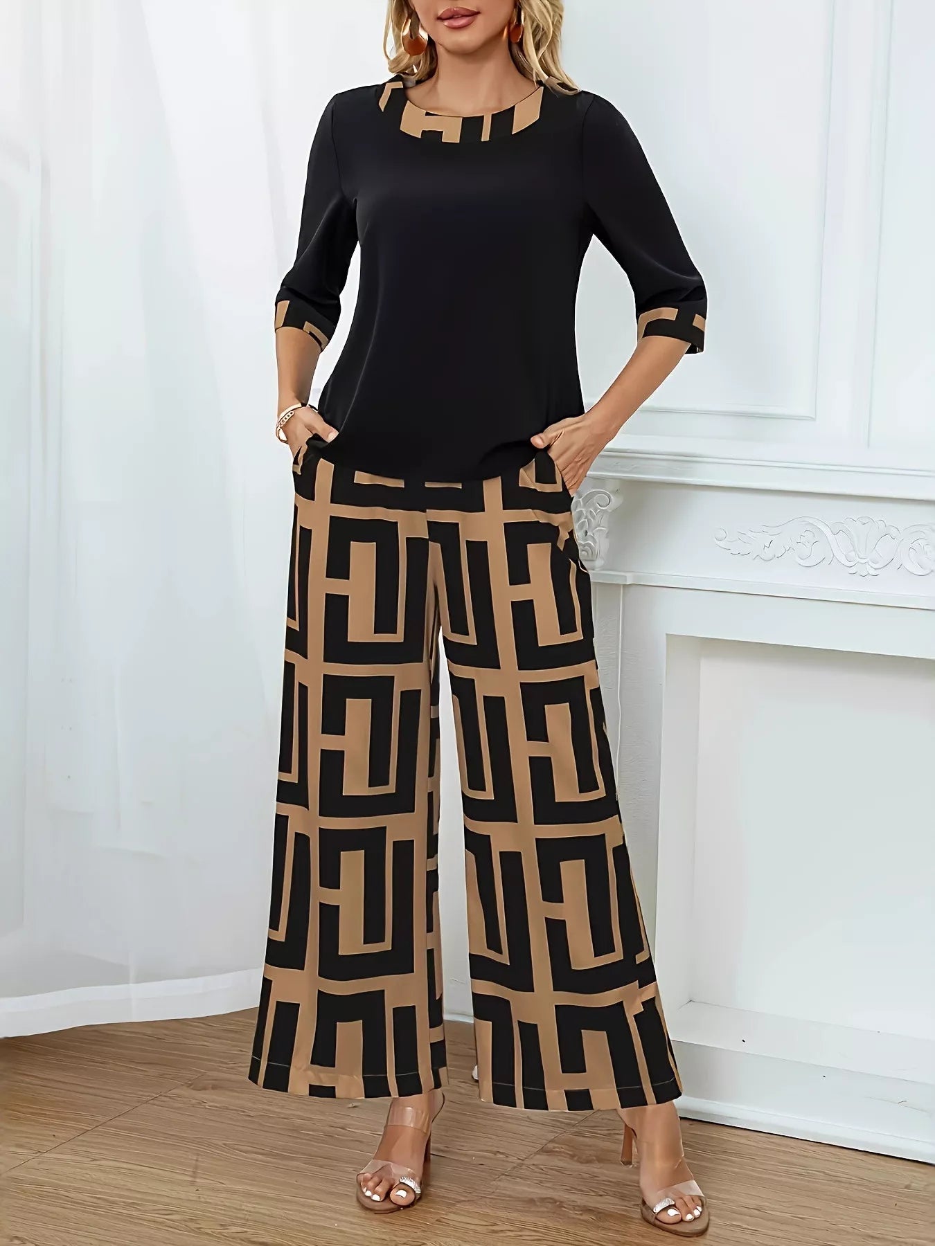 Woman wearing two-piece set with geometric print round neck top and matching pants in black and beige