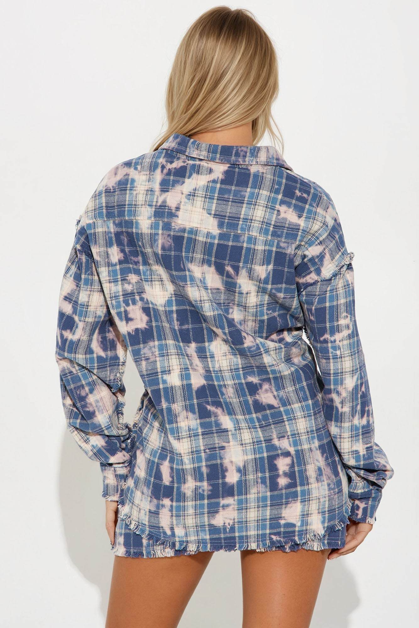 Back view of woman wearing Brianne Plaid Skirt Set in blue combo with long sleeves and distressed details