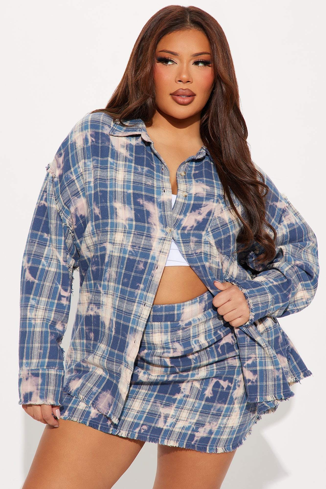 Woman wearing blue combo Brianne Plaid Skirt Set with button-up shirt and mini skirt