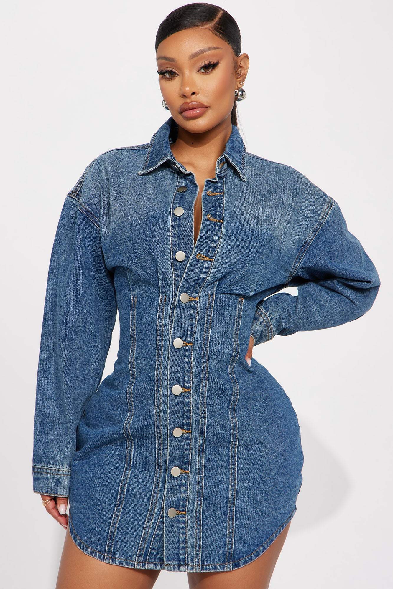 Woman wearing medium wash Alessandra Denim Mini Dress with button-down front and long sleeves