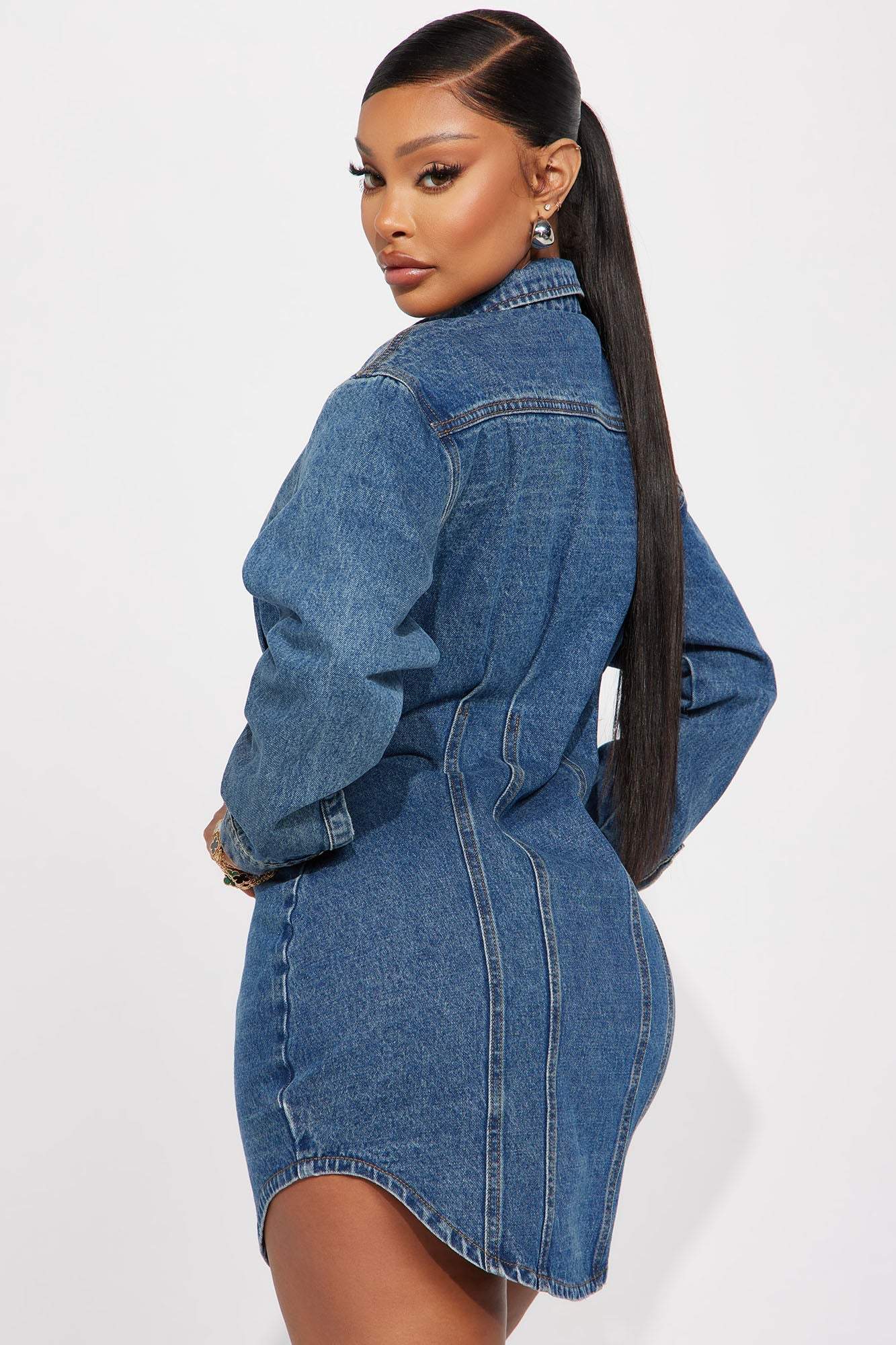 Woman wearing Alessandra Denim Mini Dress in medium wash, back view