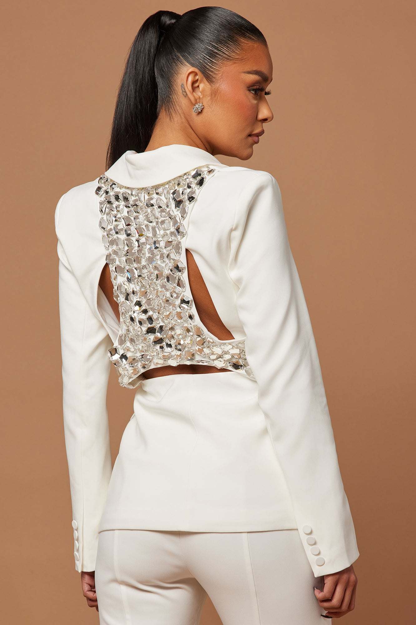 Woman wearing white Skyla embellished blazer suit set with mirror detail on back