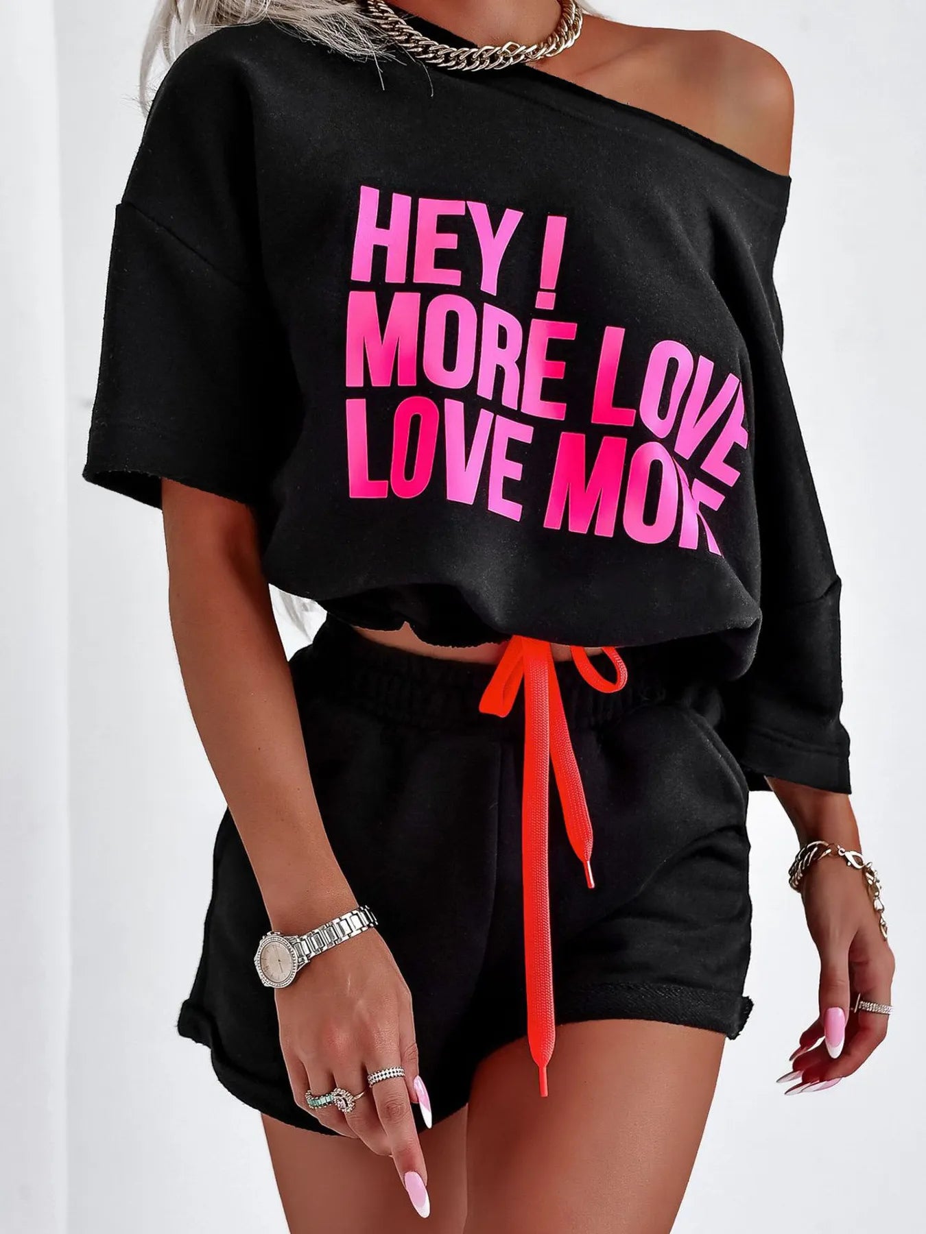 Black letter graphic top with pink text and matching shorts set with orange drawstring