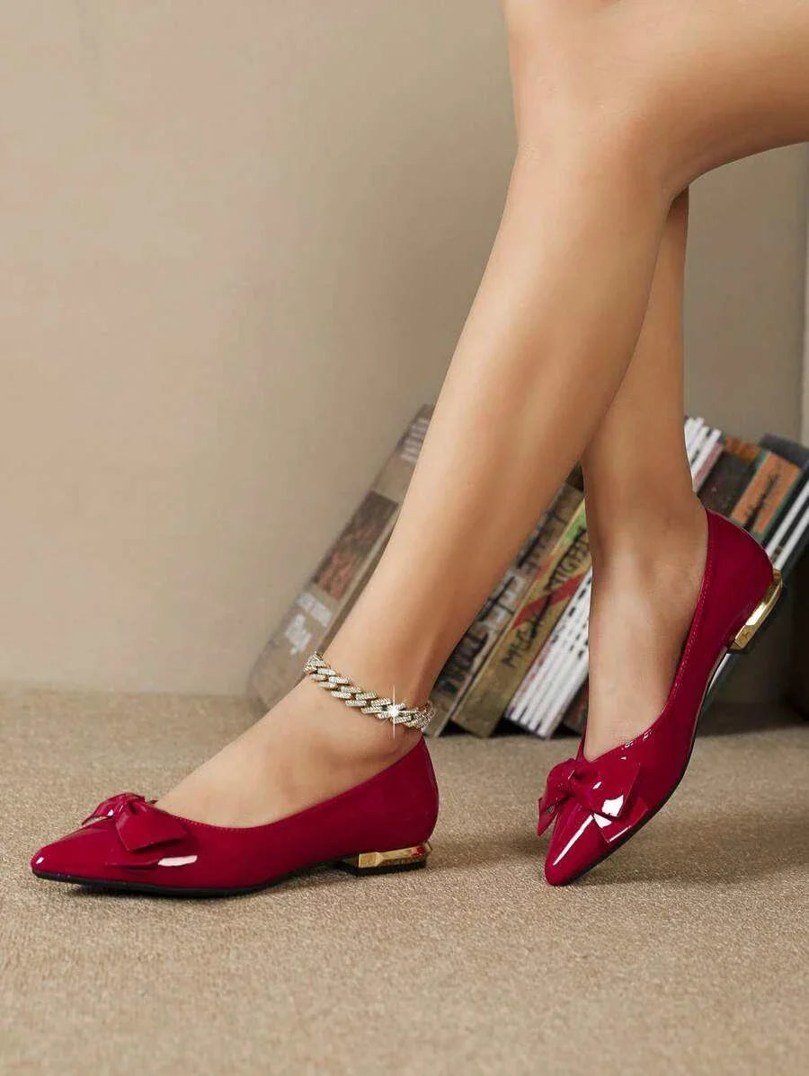 Red women bow decor point toe flats with gold heel detail and ankle chain accessory