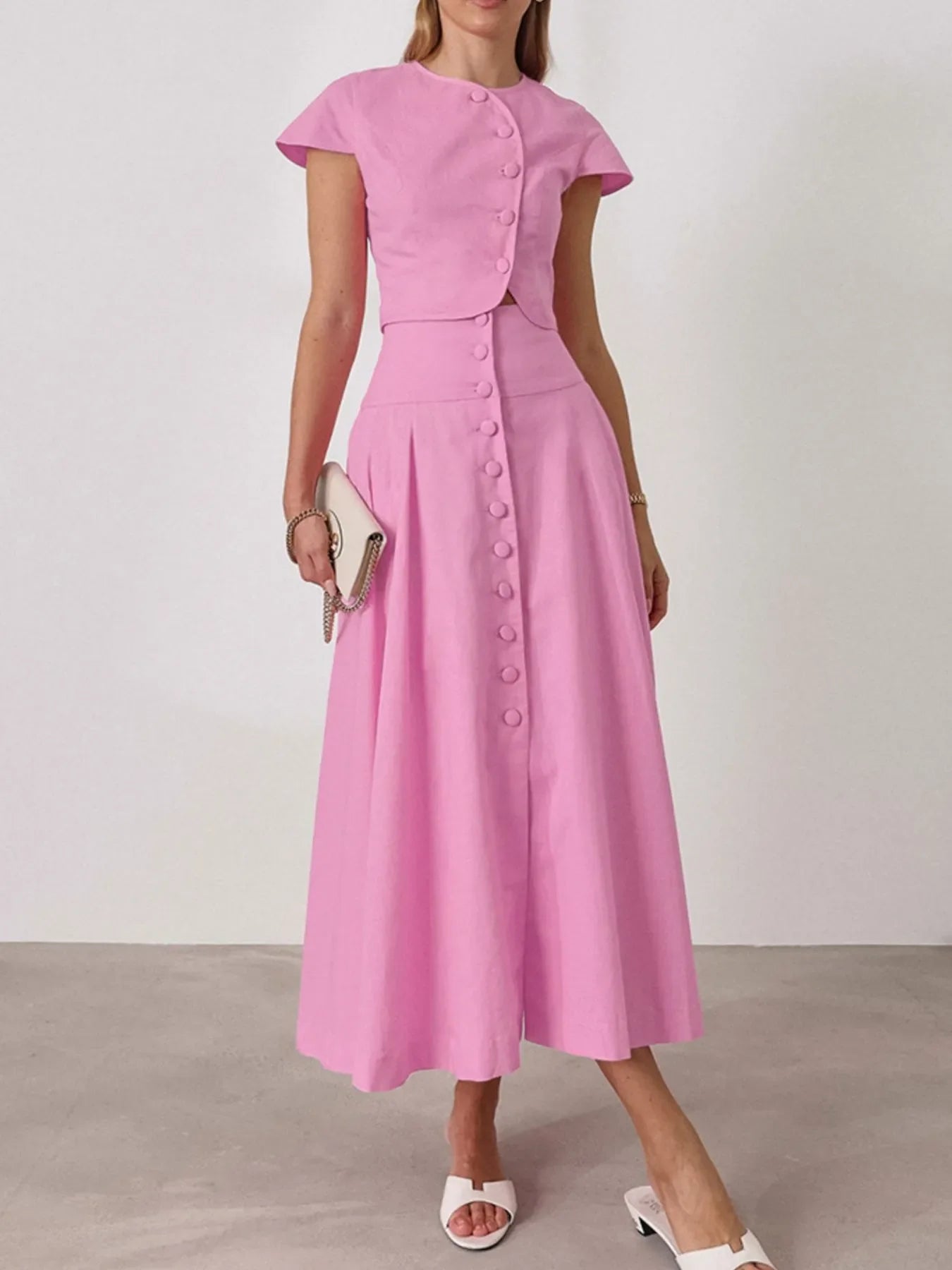 Pink two-piece short sleeve top and skirt set with buttons, 100% cotton, no stretch.