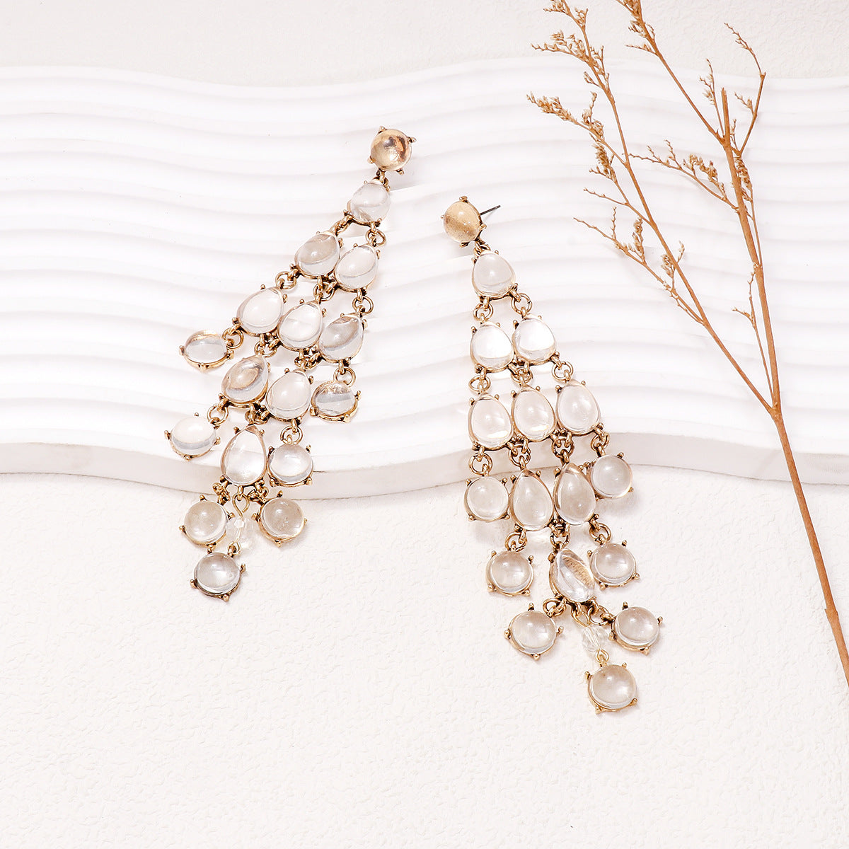 Alloy and rhinestone teardrop dangle earrings with white stones and gold-tone metal