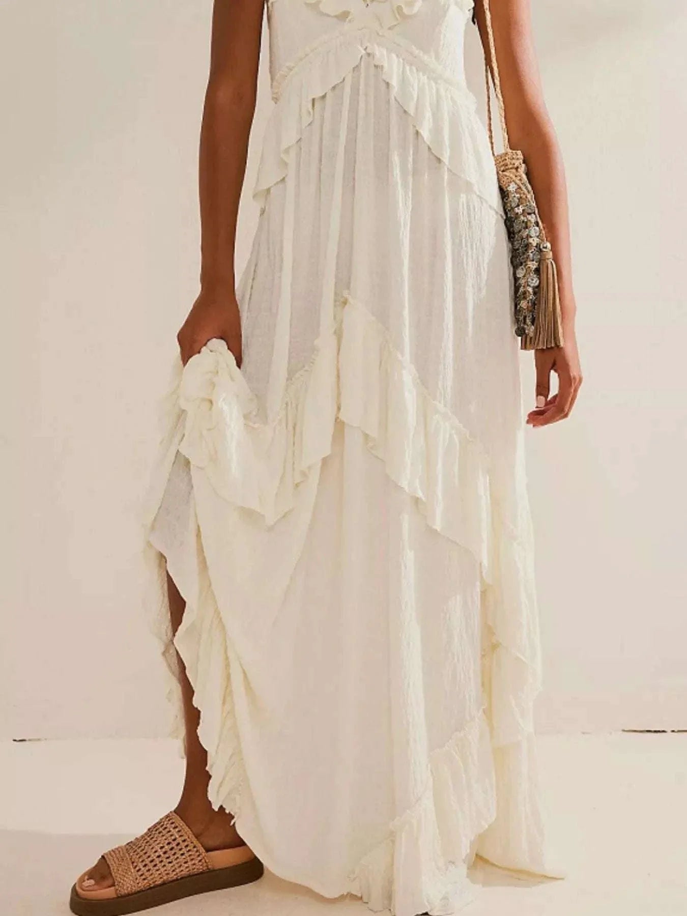 White ruffled halter neck maxi dress with tied details and layered skirt