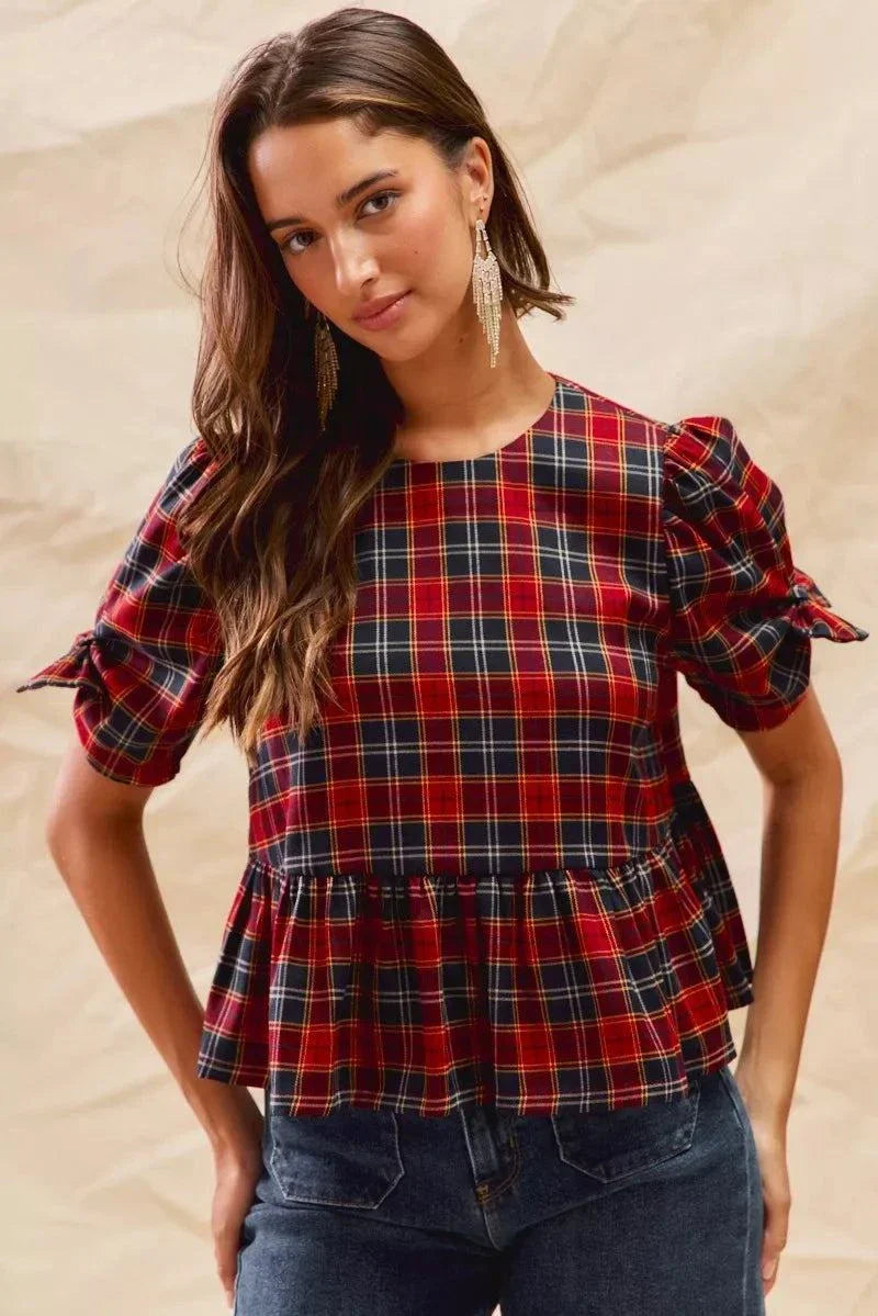 Woman wearing Christmas holiday plaid ribbon short sleeves top with ruffled hem and tied sleeves