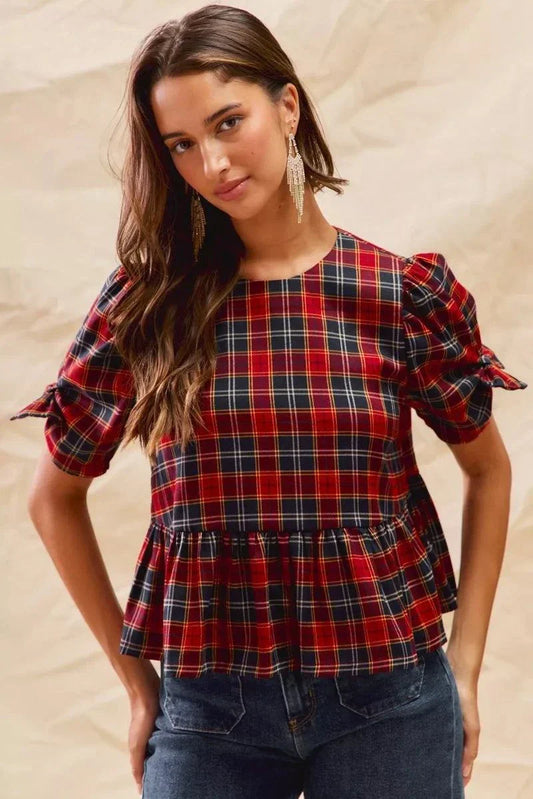 Woman wearing Christmas holiday plaid ribbon short sleeves top with ruffled hem and tied sleeves