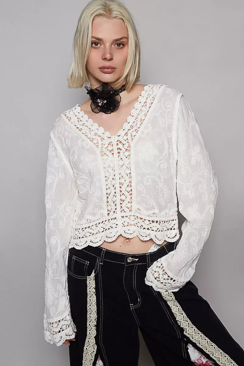 POL Long Sleeve Cropped Crochet Top with floral embroidery in white, modeled with black pants.