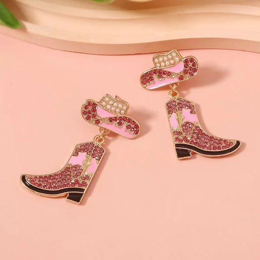 Pair of rhinestone boot dangle earrings with pink and gold accents and synthetic pearl details
