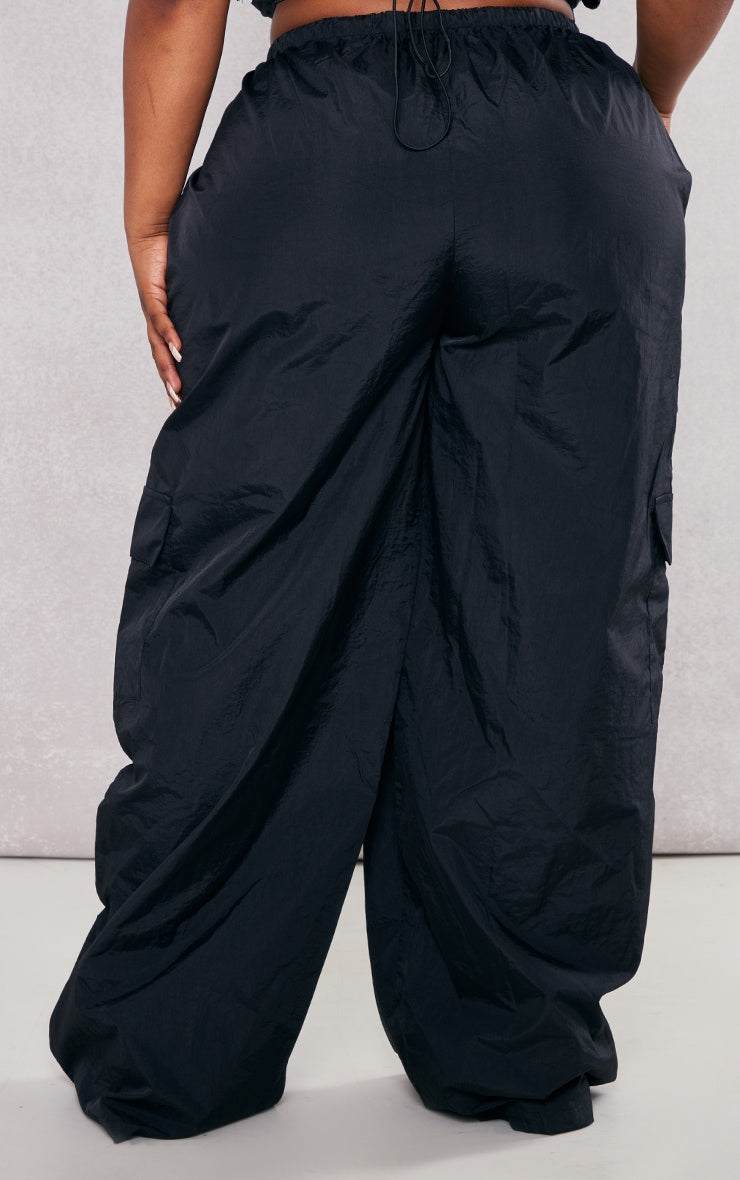 Plus Black Nylon Wide Leg Cargo TrousersReimagine your everyday uniform with these black nylon wide-leg cargo trousers. Cut from a durable, subtly textured nylon, they offer both structure and a relaxed siRedemption By Ashley NorthPlus Black Nylon