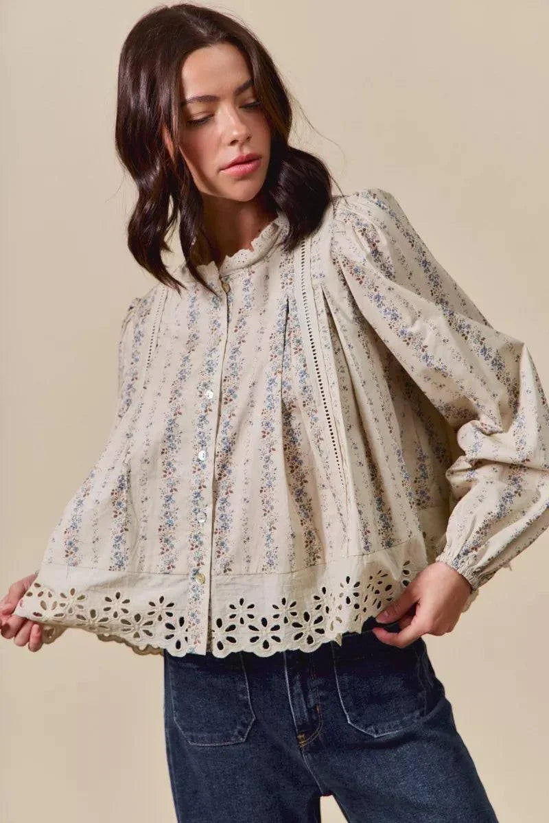 woman wearing floral print lace button down shirt with eyelet detailing and ruffled collar