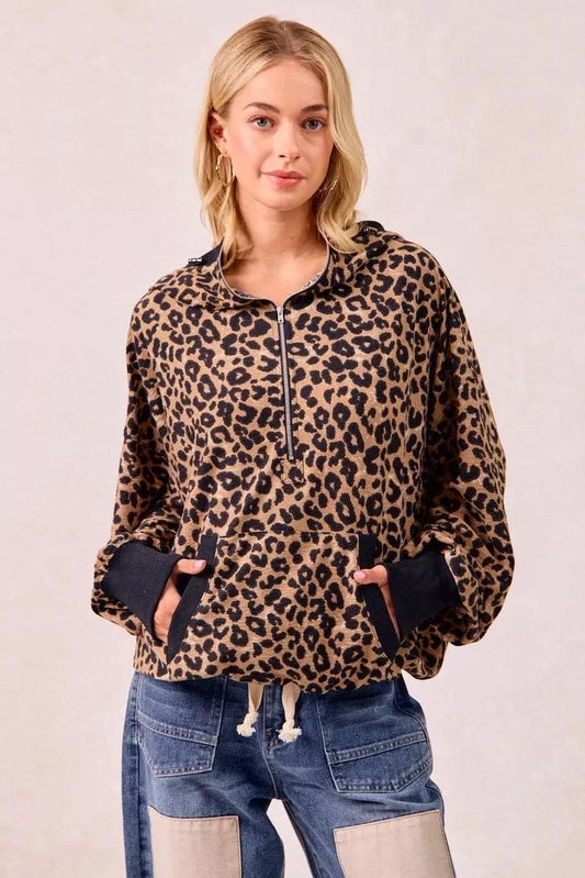 Leopard print waffle half zip hoodie with pocket and drawstring cuffs worn by woman