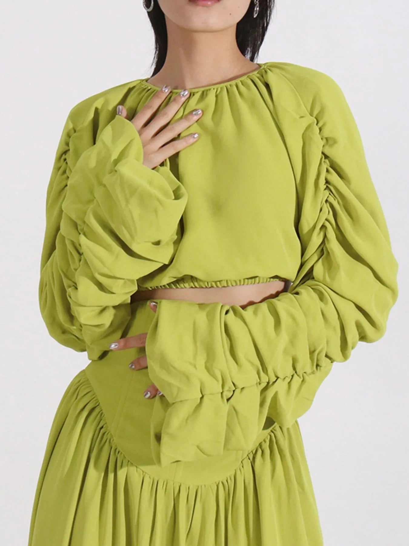 Green ruched long sleeve top paired with matching high waist skirt set