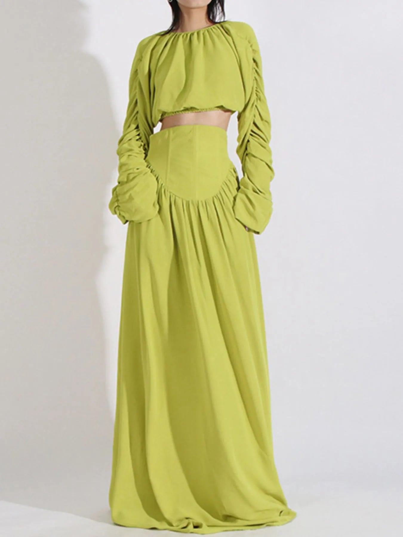 Green ruched long sleeve top and matching high waist skirt set with slight stretch, made of 100% polyester.