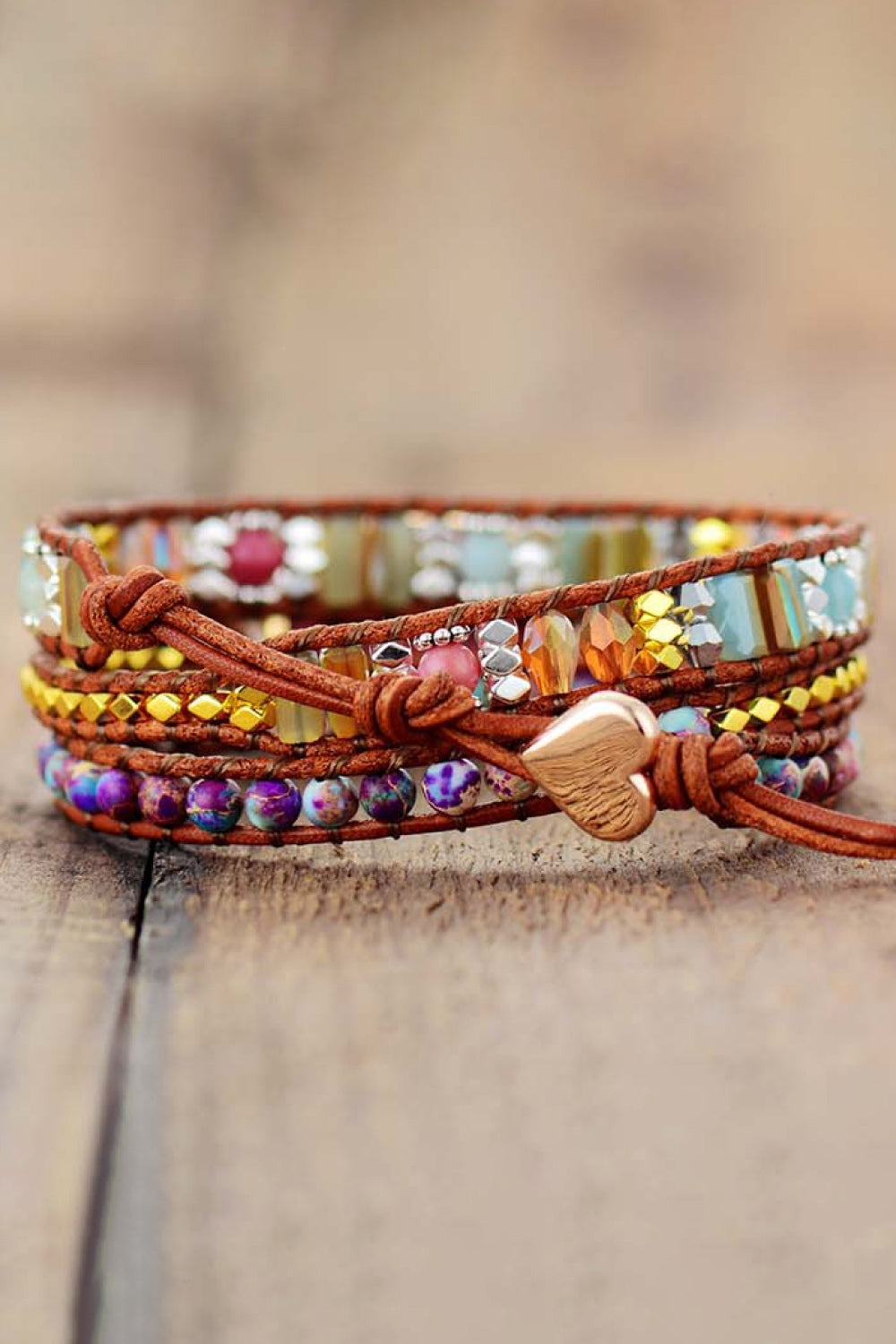 Handmade crystal beaded natural stone bracelet with multicolored beads and heart clasp on wooden surface