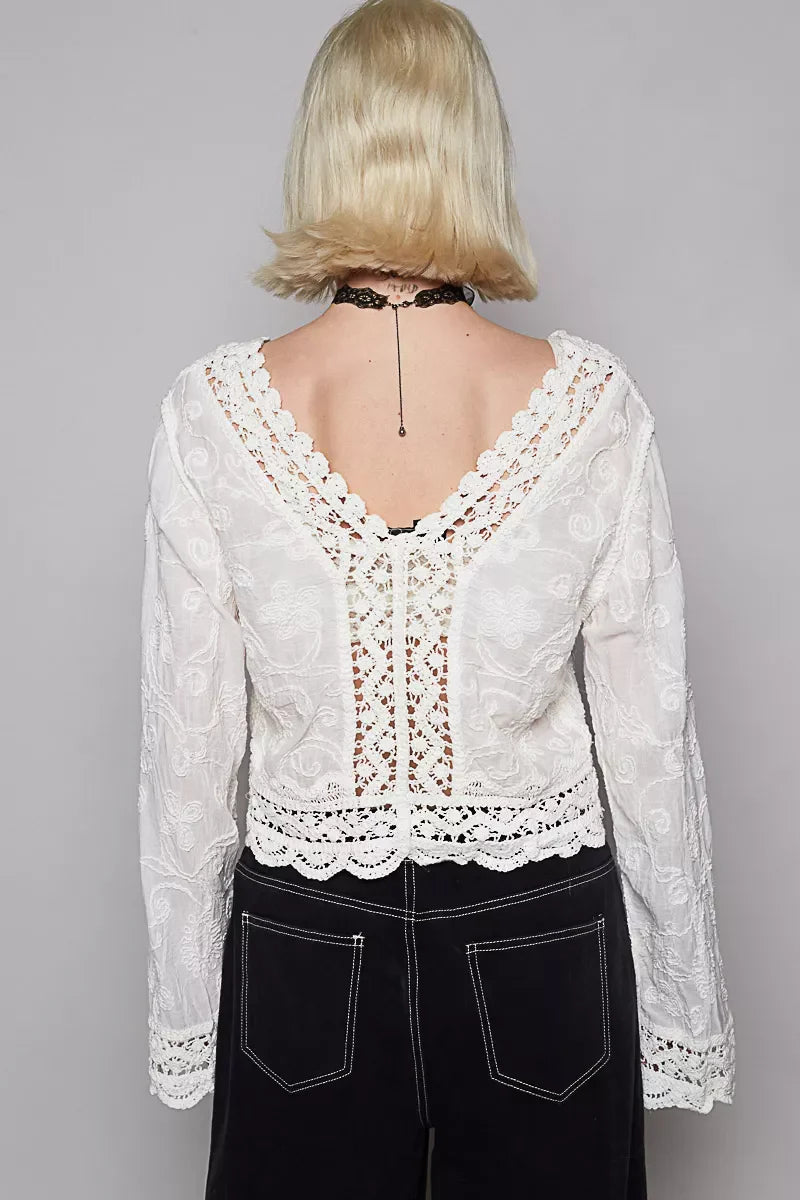 Back view of POL long sleeve cropped crochet top with floral embroidery and scalloped edges