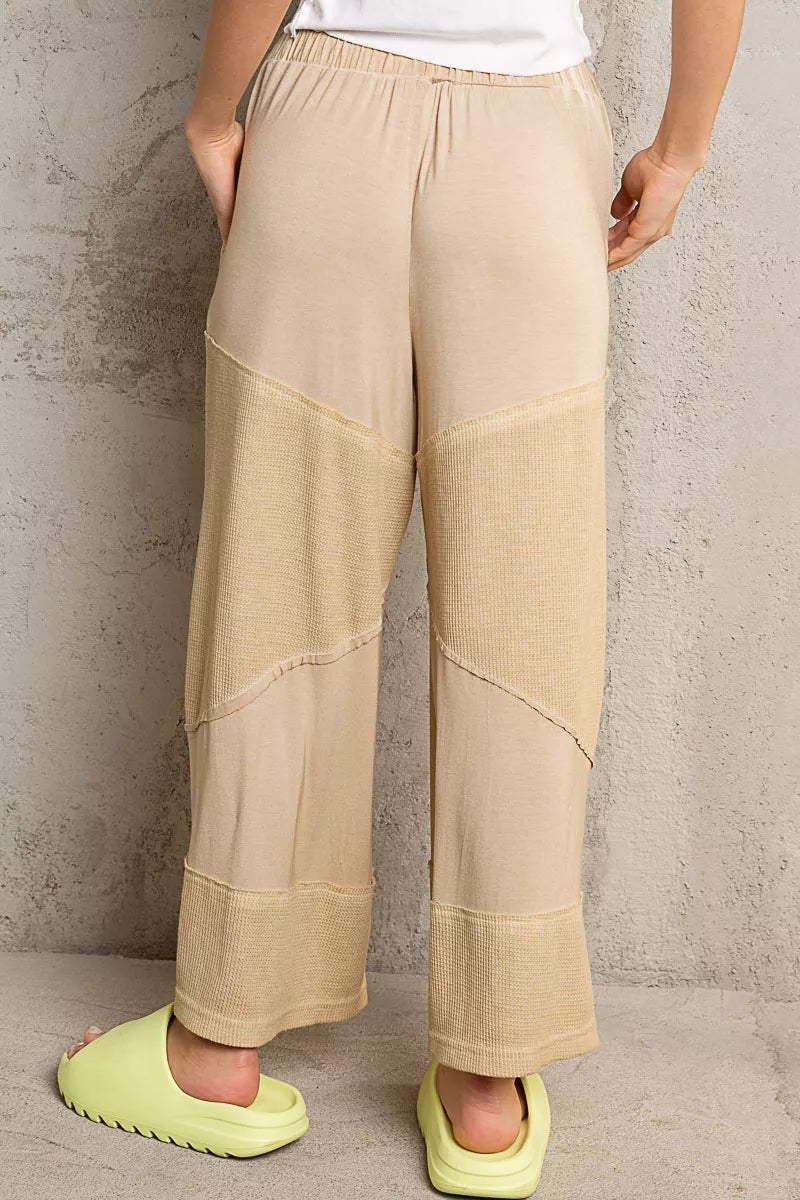 Back view of beige POL Elastic Waistband wide leg pants with drawstring and seam detail worn with lime green slide sandals