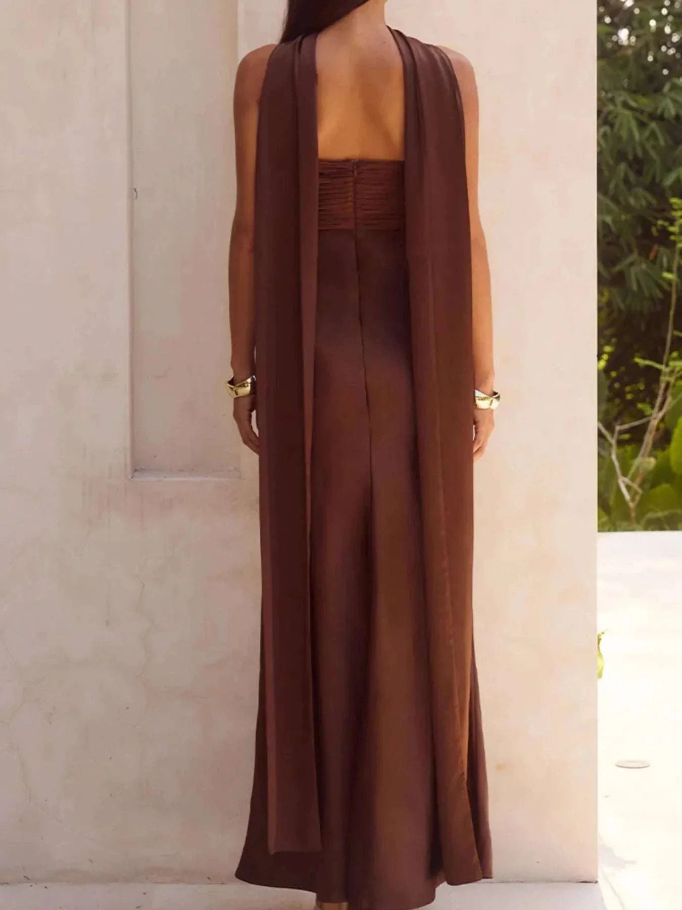 back view of brown tube mermaid maxi dress with zipper and slit detail