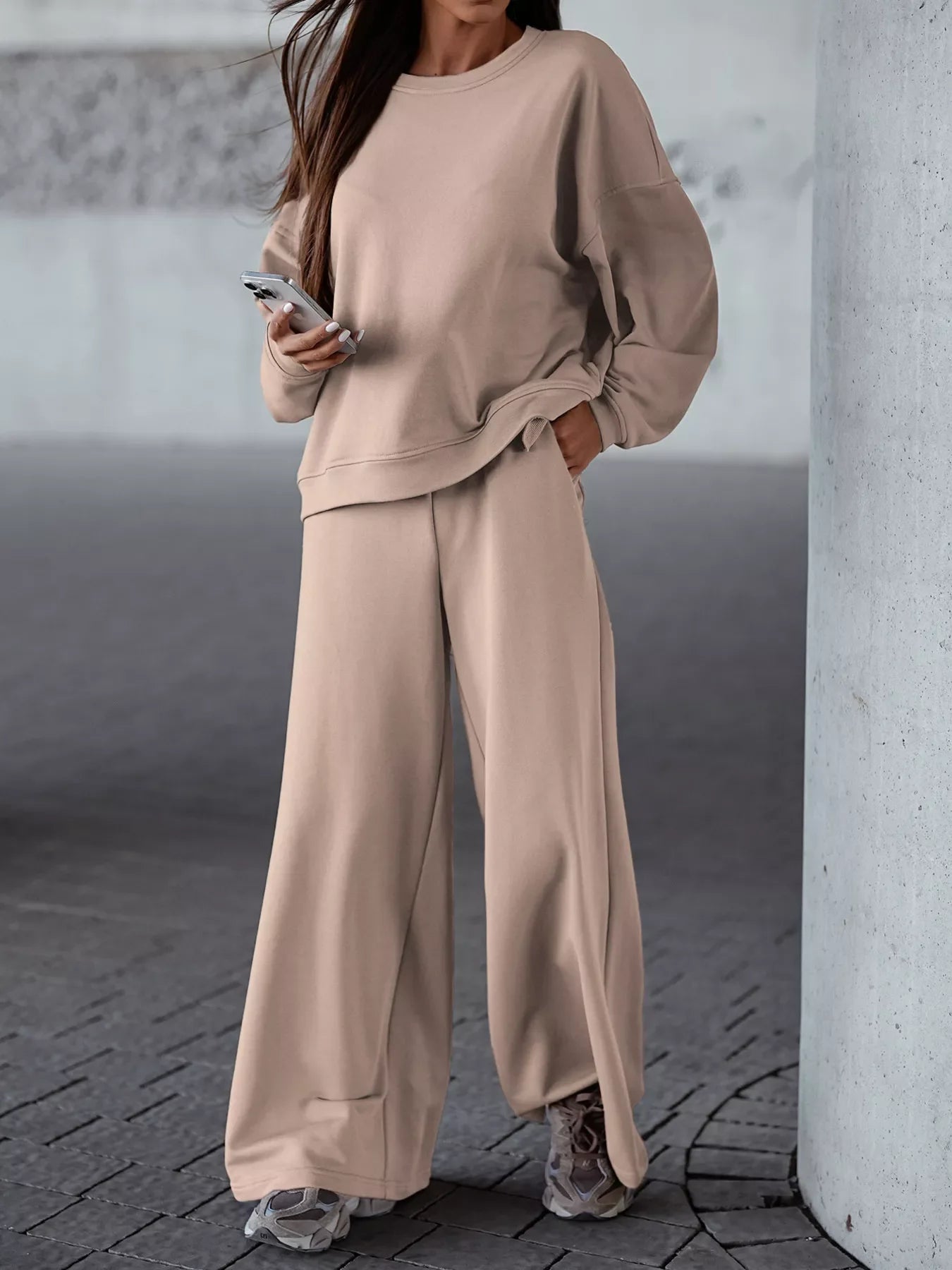 Woman wearing beige casual loose fit top and wide-leg pants two-piece set with pockets