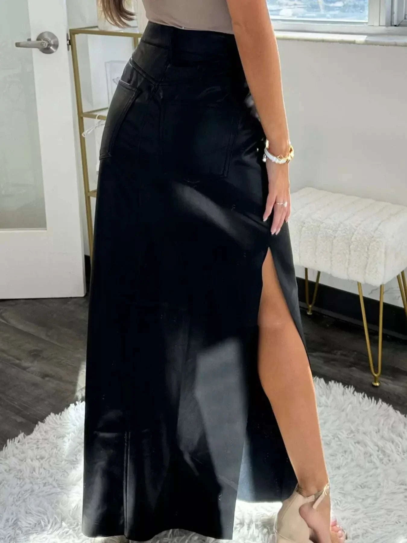 Black leather high-waist maxi skirt with side slit and back pockets