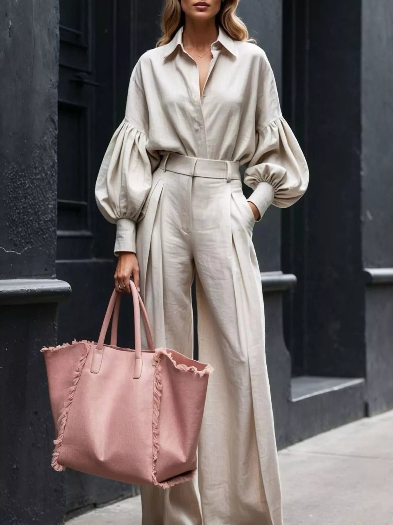 Beige lantern sleeve shirt paired with matching wide leg pants and pink tote bag on a street background