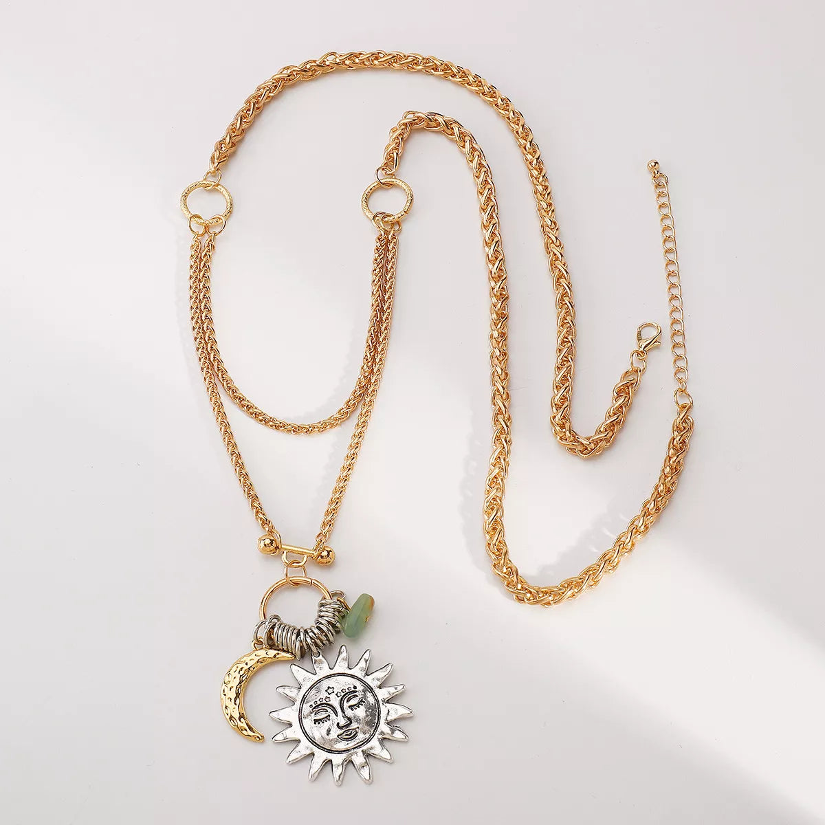 Moon & Sun Pendant necklace with 18K gold plating and silver-plated sun and moon charms on a gold chain
