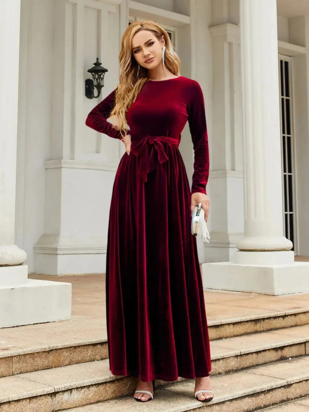 Woman wearing a burgundy tie front round neck long sleeve maxi dress