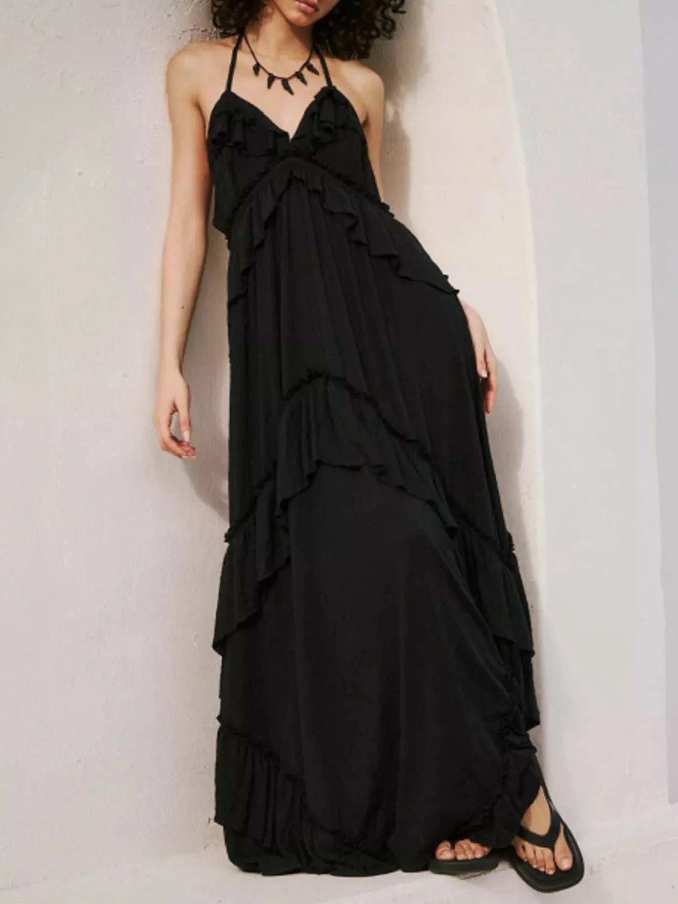 Black ruffled halter neck maxi dress with tiered layers and tie neck detail