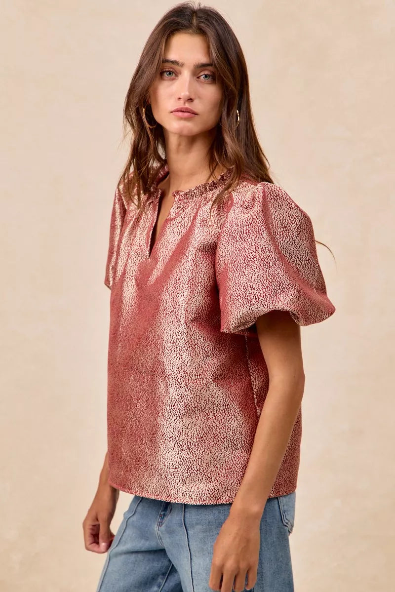 Woman wearing BiBi Jacquard Woven short balloon sleeves V neck top in pink patterned fabric.