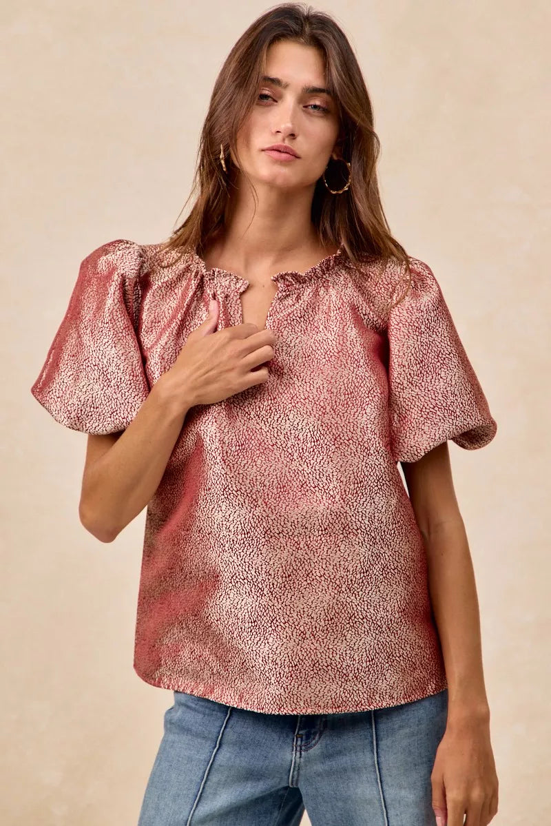 Woman wearing BiBi Jacquard Woven short balloon sleeves V neck top in pink with ruffled neckline and textured fabric